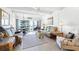 Inviting living room with coastal decor, comfortable seating, and sliding glass doors to a balcony with ocean views at 4821 Saxon Dr # 201B, New Smyrna Beach, FL 32169