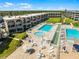 Beautiful pool area with lounging spaces, and well manicured landscaping at 4821 Saxon Dr # 201B, New Smyrna Beach, FL 32169