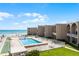 An inviting pool and lounge area with shuffleboard courts offer relaxation and recreation by the beach at 4821 Saxon Dr # 201B, New Smyrna Beach, FL 32169