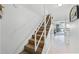 A carpeted staircase with white railings provides access to the living area with beach view at 4821 Saxon Dr # 201B, New Smyrna Beach, FL 32169