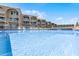 Sparkling swimming pool with lounge chairs and building exterior in the background at 4821 Saxon Dr # 201B, New Smyrna Beach, FL 32169