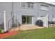 Backyard patio with sliding glass doors, grill, and fenced-in yard area at 4917 Walden Cir, Orlando, FL 32811