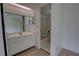 This bathroom features a vanity and a tub with white tile surround, with natural light at 4917 Walden Cir, Orlando, FL 32811