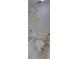 This bathroom includes a standard toilet, shower with white tiled walls and silver fixtures at 4917 Walden Cir, Orlando, FL 32811