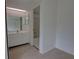 This bathroom features a sky light, vanity, and a tub with white tile surround at 4917 Walden Cir, Orlando, FL 32811