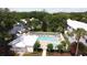 Aerial view of the community pool with lounge chairs and lush landscaping at 4917 Walden Cir, Orlando, FL 32811