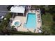 Aerial view of the community pool and spa, surrounded by lounge chairs and a cabana at 4917 Walden Cir, Orlando, FL 32811