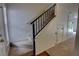 View of the staircase featuring carpeted steps and a black metal railing to the second floor at 4917 Walden Cir, Orlando, FL 32811