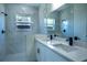 Modern bathroom featuring dual sinks, quartz counters, and tiled shower at 5 Fisher Loop, Ocklawaha, FL 32179