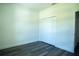 A bedroom featuring a closet with bi-fold doors and modern laminate flooring at 5 Fisher Loop, Ocklawaha, FL 32179