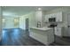 Open-concept kitchen with a large island, stainless appliances, and hardwood floors at 5 Fisher Loop, Ocklawaha, FL 32179