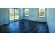 Bright and airy living room with hardwood floors and large sliding glass door at 5 Fisher Loop, Ocklawaha, FL 32179
