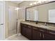 Bathroom features a double sink vanity with granite countertop, walk in shower at 5412 Factors Walk Dr, Sanford, FL 32771