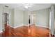 Spacious bedroom with hardwood floors, ceiling fan, and doorways leading to a bathroom and closet at 5412 Factors Walk Dr, Sanford, FL 32771