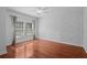 This bedroom features wood floors, large window, and decorative wall at 5412 Factors Walk Dr, Sanford, FL 32771