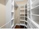 Walk-in closet with custom shelving and hanging rods for ample storage space at 5412 Factors Walk Dr, Sanford, FL 32771