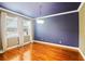 Formal dining room with blue accent wall, hardwood floors, contemporary chandelier and large windows at 5412 Factors Walk Dr, Sanford, FL 32771