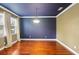 Bright dining room featuring hardwood floors, crown molding, and modern light fixture at 5412 Factors Walk Dr, Sanford, FL 32771