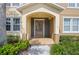 Close-up of home's entryway showing front door with sidelights and decorative archway at 5412 Factors Walk Dr, Sanford, FL 32771