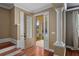 Welcoming entryway with hardwood floors and decorative column, opening to a sunlit porch at 5412 Factors Walk Dr, Sanford, FL 32771