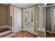 Inviting entryway with hardwood stairs, a decorative column, and natural light through a glass front door at 5412 Factors Walk Dr, Sanford, FL 32771