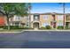 Inviting townhome featuring a beige exterior, manicured landscaping, and an American flag waving near the entrance at 5412 Factors Walk Dr, Sanford, FL 32771