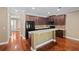 A stylish kitchen featuring dark wood cabinets, stainless steel appliances, and a breakfast bar at 5412 Factors Walk Dr, Sanford, FL 32771