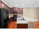 Modern kitchen features dark wood cabinets, black appliances, and a spacious island for food preparation at 5412 Factors Walk Dr, Sanford, FL 32771