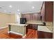 Modern kitchen features dark wood cabinets, black appliances, and a spacious island for food preparation at 5412 Factors Walk Dr, Sanford, FL 32771