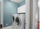 Laundry room features washer and dryer with overhead cabinets at 5412 Factors Walk Dr, Sanford, FL 32771