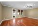 Bright living room featuring hardwood floors, ceiling fan and multiple windows for natural light at 5412 Factors Walk Dr, Sanford, FL 32771