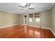 Bright living room featuring hardwood floors, ceiling fan and multiple windows for natural light at 5412 Factors Walk Dr, Sanford, FL 32771