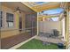 Screened in patio with fan, paver flooring, and synthetic lawn beyond at 5412 Factors Walk Dr, Sanford, FL 32771