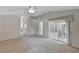 Large bedroom featuring neutral-toned walls, a ceiling fan, and sliding glass doors to the outdoor patio area at 602 Westview Dr, Minneola, FL 34715