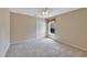 Bedroom with neutral walls and carpet, featuring a window, closet, and ceiling fan at 602 Westview Dr, Minneola, FL 34715