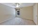 Bedroom with neutral walls and carpet featuring a window with views of greenery and a ceiling fan at 602 Westview Dr, Minneola, FL 34715