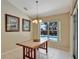 Dining area offering a view of the pool, featuring tiled floors, chandelier and decor art on the walls at 602 Westview Dr, Minneola, FL 34715