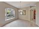 Inviting dining room featuring a window with a view, chandelier, and light-colored carpet, creating a bright and airy ambiance at 602 Westview Dr, Minneola, FL 34715