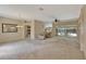 Spacious open-concept living room with neutral tones, seamlessly connected to the kitchen and dining area, offering views of the pool at 602 Westview Dr, Minneola, FL 34715