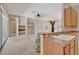Inviting living room with built-in shelving, carpeted flooring, and a partial view of the kitchen counter at 602 Westview Dr, Minneola, FL 34715
