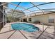 Screened-in pool with tile border, spacious patio, and lush landscaping, ideal for outdoor enjoyment at 602 Westview Dr, Minneola, FL 34715