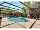Inviting screened-in pool with a patio area, surrounded by lush landscaping for privacy and beauty at 602 Westview Dr, Minneola, FL 34715
