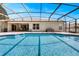 Sparkling swimming pool with blue tile and covered with a screen, perfect for outdoor relaxation and entertainment at 602 Westview Dr, Minneola, FL 34715
