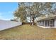 Large grassy backyard enclosed with a white fence and mature trees at 621 Ashberry Ln, Altamonte Springs, FL 32714
