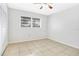 A clean and well-lit bedroom features neutral colors, tiled floors, and a closet at 621 Ashberry Ln, Altamonte Springs, FL 32714