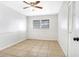 A clean and well-lit bedroom features neutral colors, tiled floors, ceiling fan, and a closet at 621 Ashberry Ln, Altamonte Springs, FL 32714