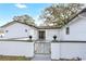 Inviting entryway with a decorative gate, modern touches, and fresh landscaping at 621 Ashberry Ln, Altamonte Springs, FL 32714