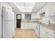 Bright kitchen with white cabinetry, granite countertops, and tiled flooring at 621 Ashberry Ln, Altamonte Springs, FL 32714