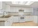 Functional kitchen featuring white appliances, stone countertops and ample cabinet space at 621 Ashberry Ln, Altamonte Springs, FL 32714