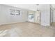 Open-concept living space with large windows and neutral tile flooring throughout at 621 Ashberry Ln, Altamonte Springs, FL 32714